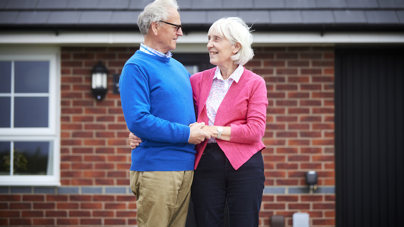 Mary and John outside their new home